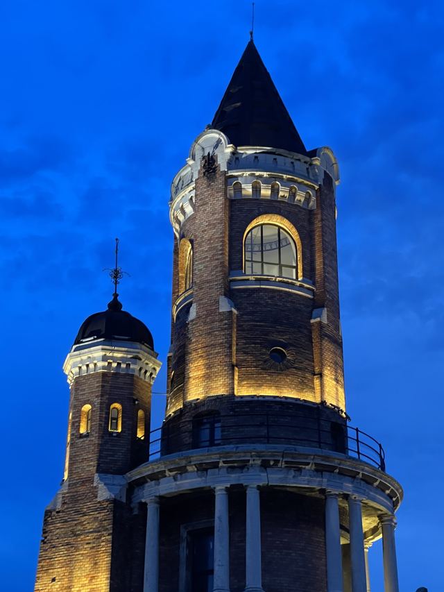 Gardoš Tower lit up at dusk against a deep blue sky
