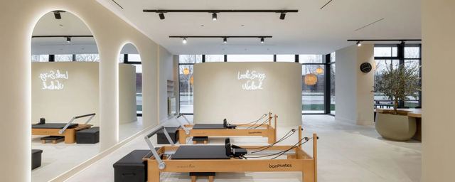 Pilates reformers between white arches at Elia Pilates Studio by the river