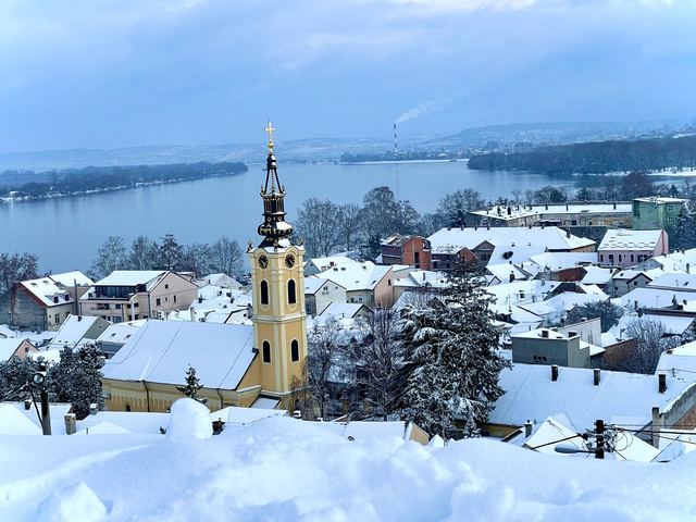 Zemun under deep snow, with the church tower and the Danube beyond