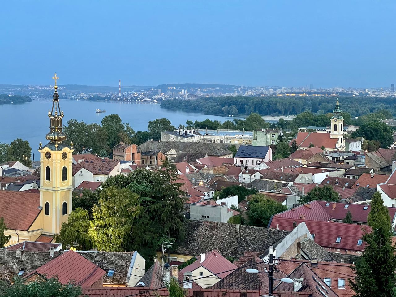 Old Zemun’s red roofs and church towers from Gardoš, with the Danube, Great War Island and Belgrade beyond